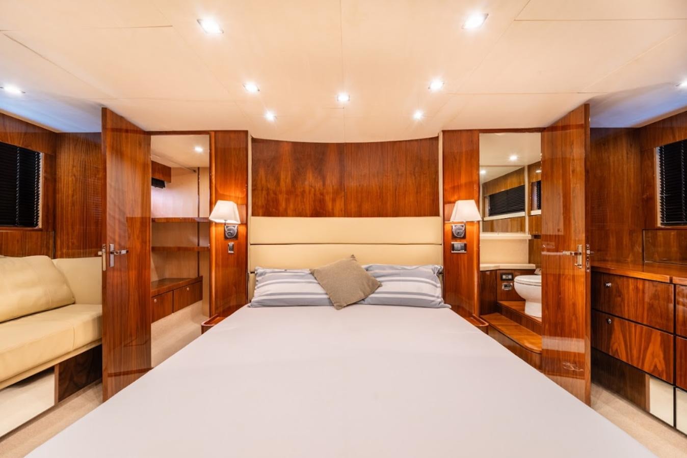 a room with a bed and a wood cabinet aboard FAIRLINE SQUADRON 70 - 2010 Yacht for Sale