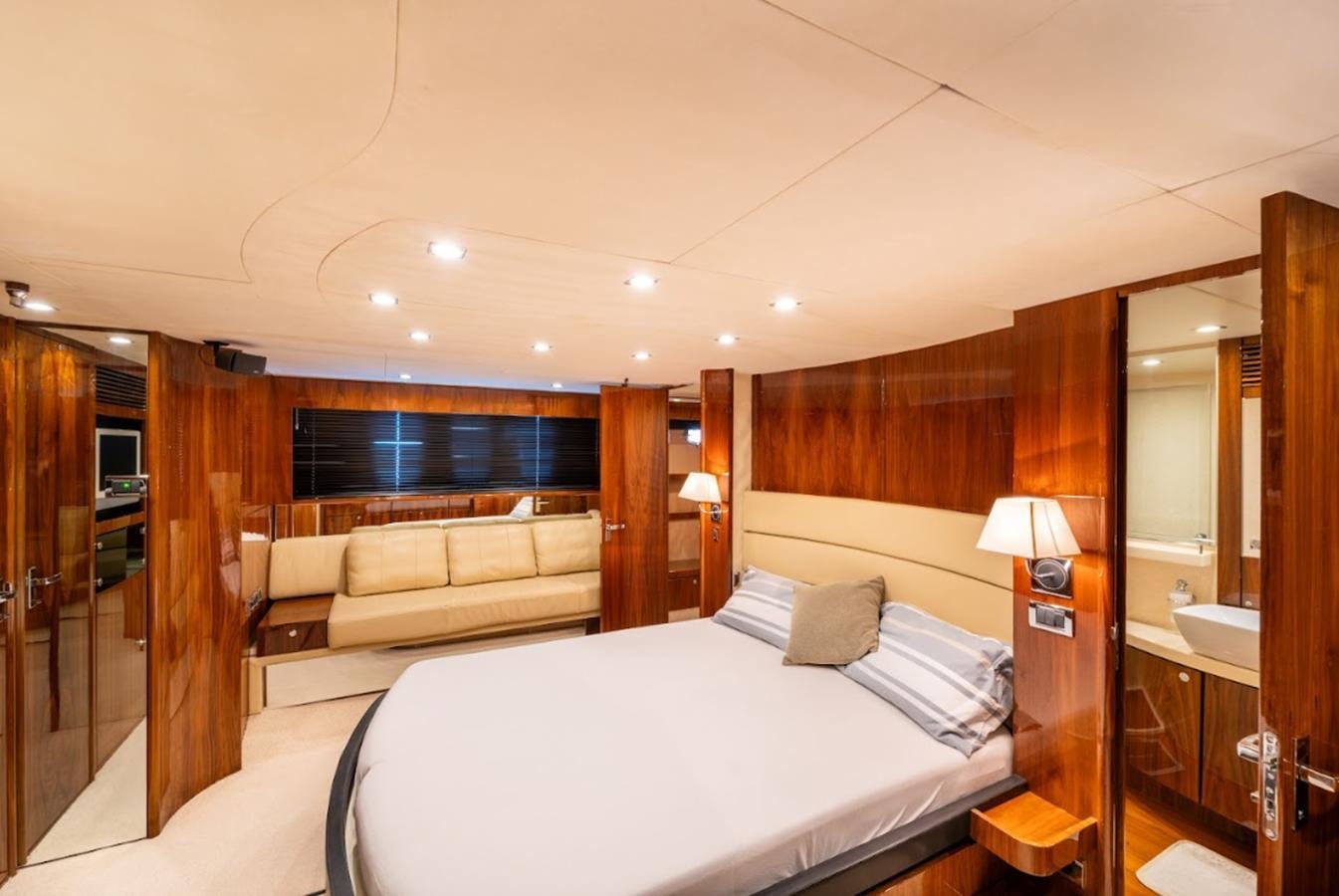 a hotel room with a bed and a couch aboard FAIRLINE SQUADRON 70 - 2010 Yacht for Sale