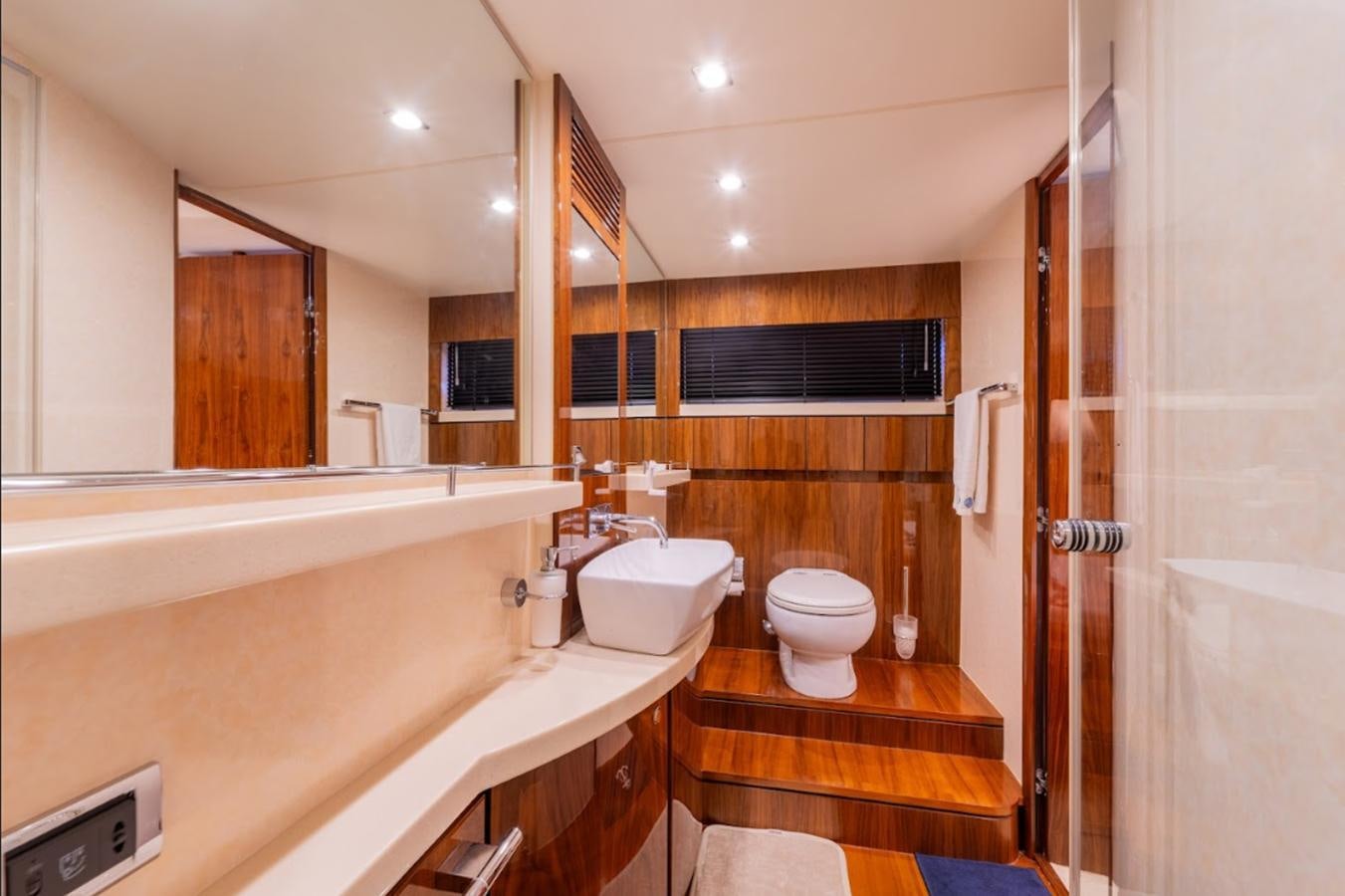 a bathroom with a tub sink and toilet aboard FAIRLINE SQUADRON 70 - 2010 Yacht for Sale