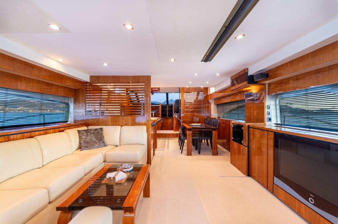 a living room with a large screen aboard FAIRLINE SQUADRON 70 - 2010 Yacht for Sale