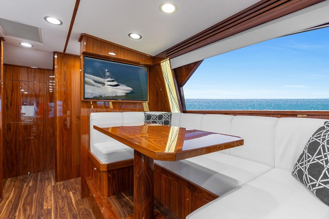 a room with a table and a bed aboard TEAM HARVEY Yacht for Sale