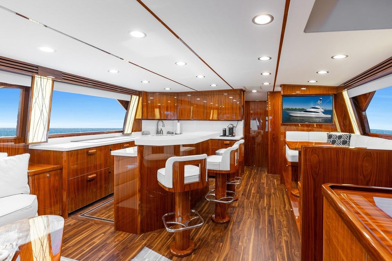 a room with wooden cabinets and a large window aboard TEAM HARVEY Yacht for Sale