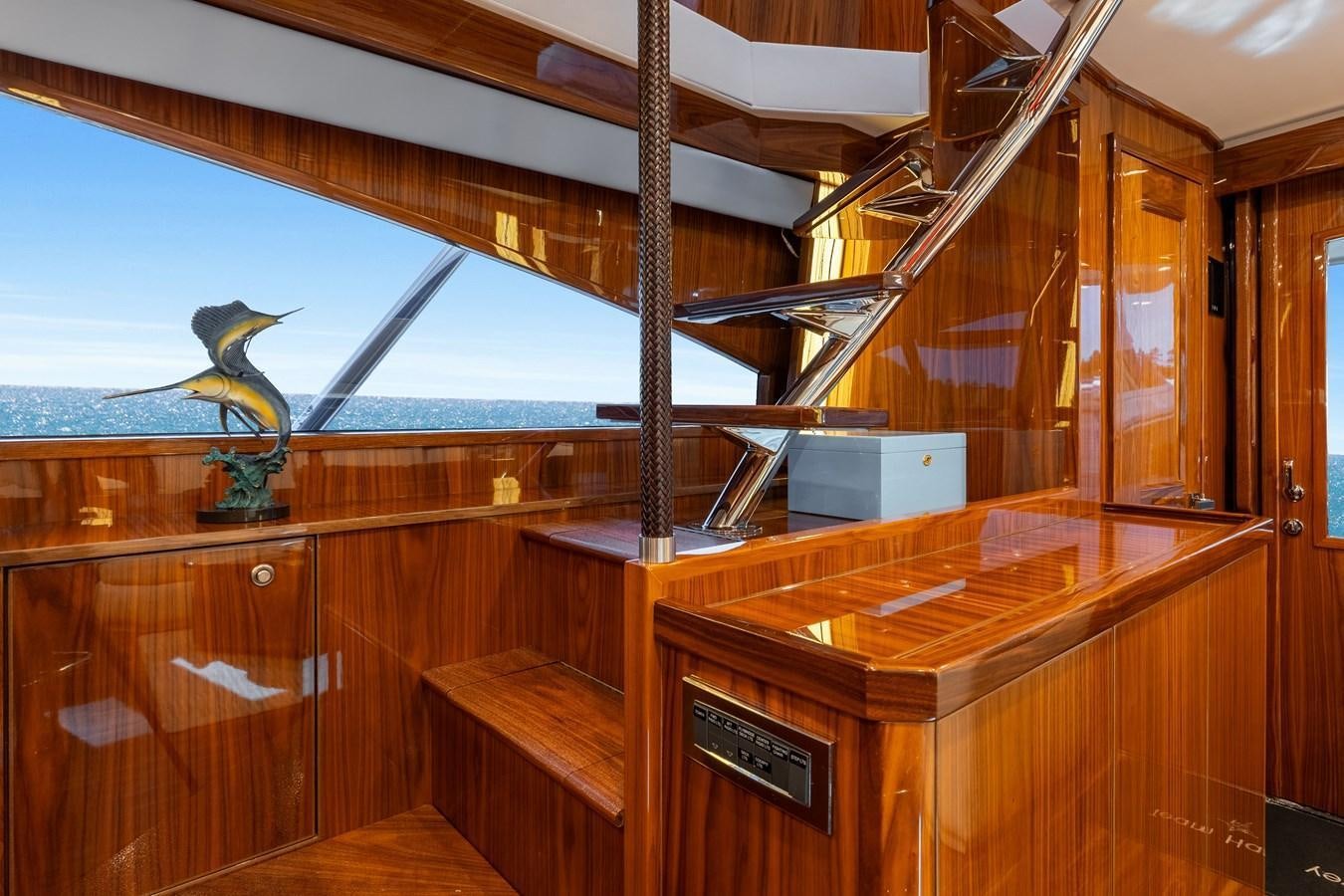 a room with a wood table and a glass window aboard TEAM HARVEY Yacht for Sale
