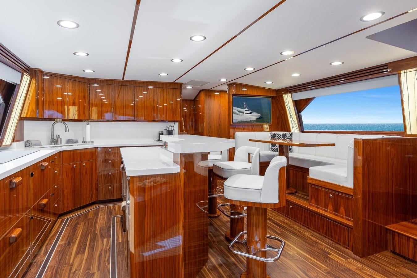 a kitchen with wooden cabinets aboard TEAM HARVEY Yacht for Sale