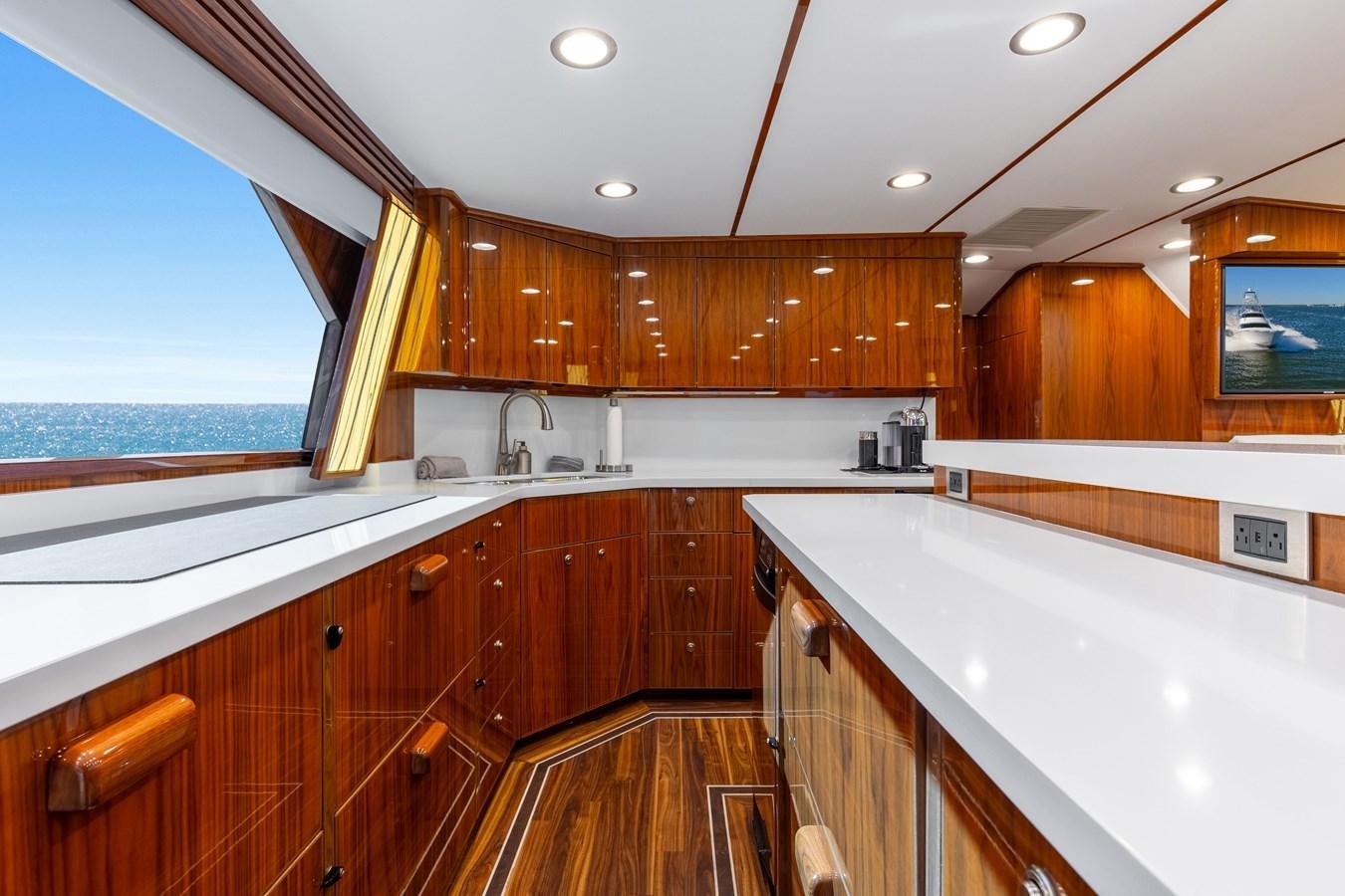 a kitchen with wooden cabinets aboard TEAM HARVEY Yacht for Sale