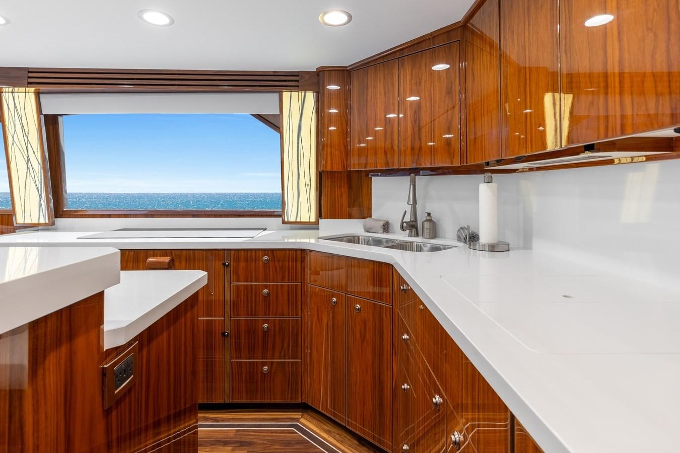 a kitchen with wooden cabinets aboard TEAM HARVEY Yacht for Sale
