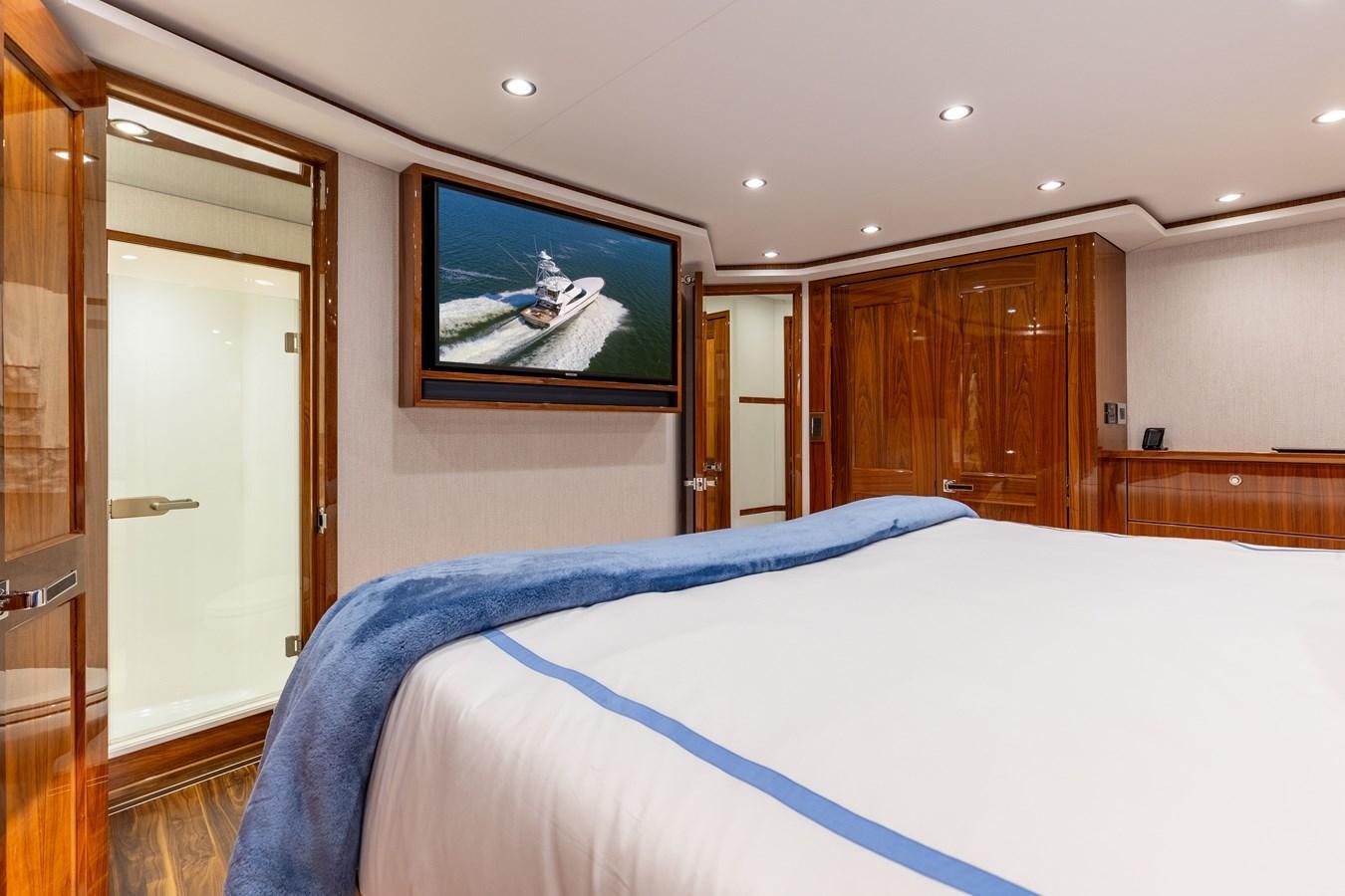 a bedroom with a tv on the wall aboard TEAM HARVEY Yacht for Sale