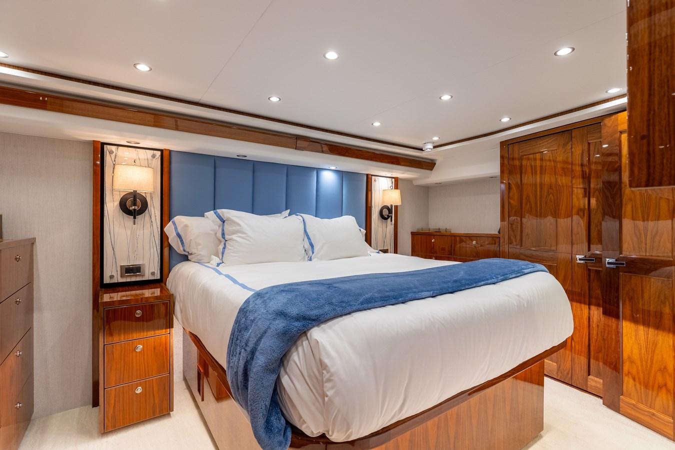a bedroom with a bed and a closet aboard TEAM HARVEY Yacht for Sale