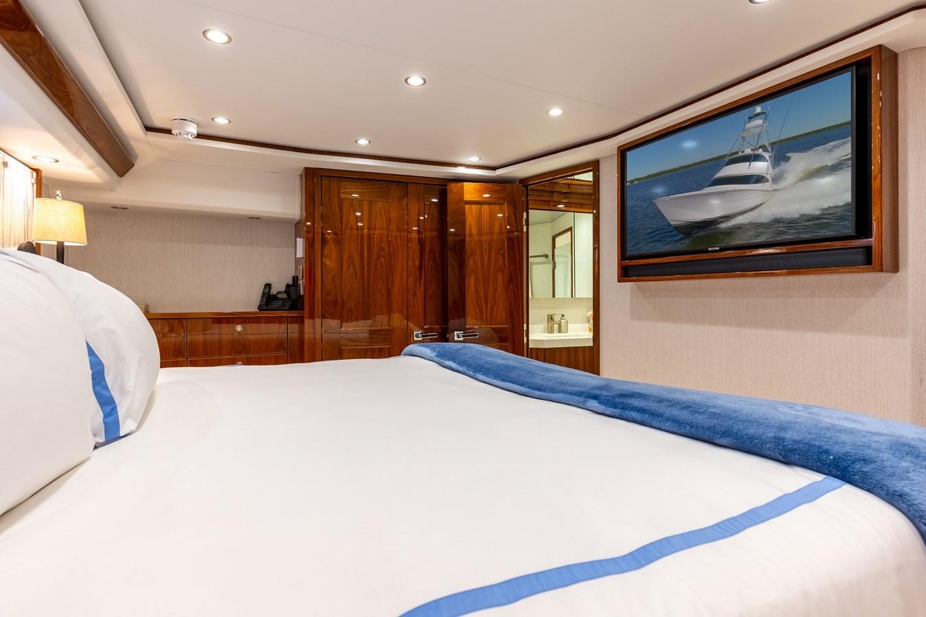 a bedroom with a large bed aboard TEAM HARVEY Yacht for Sale