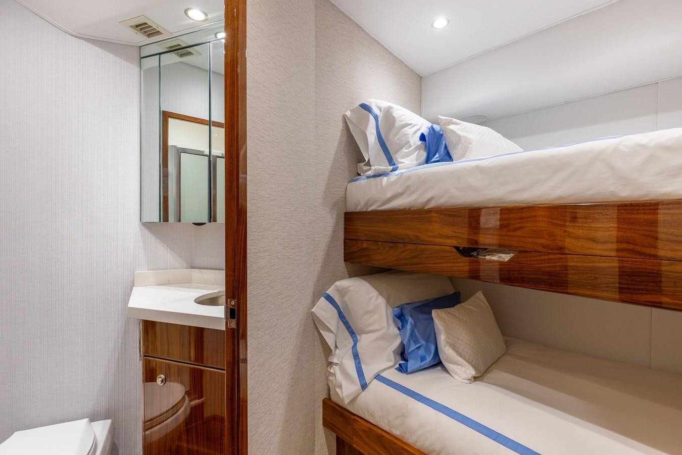 a room with a bed and a mirror aboard TEAM HARVEY Yacht for Sale
