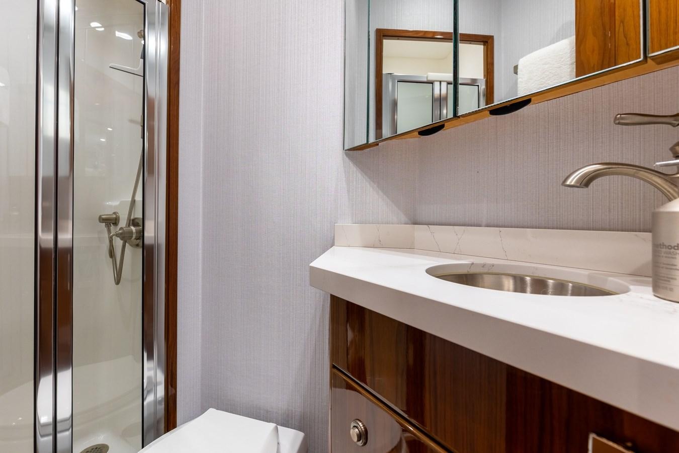 a bathroom with a sink and a mirror aboard TEAM HARVEY Yacht for Sale