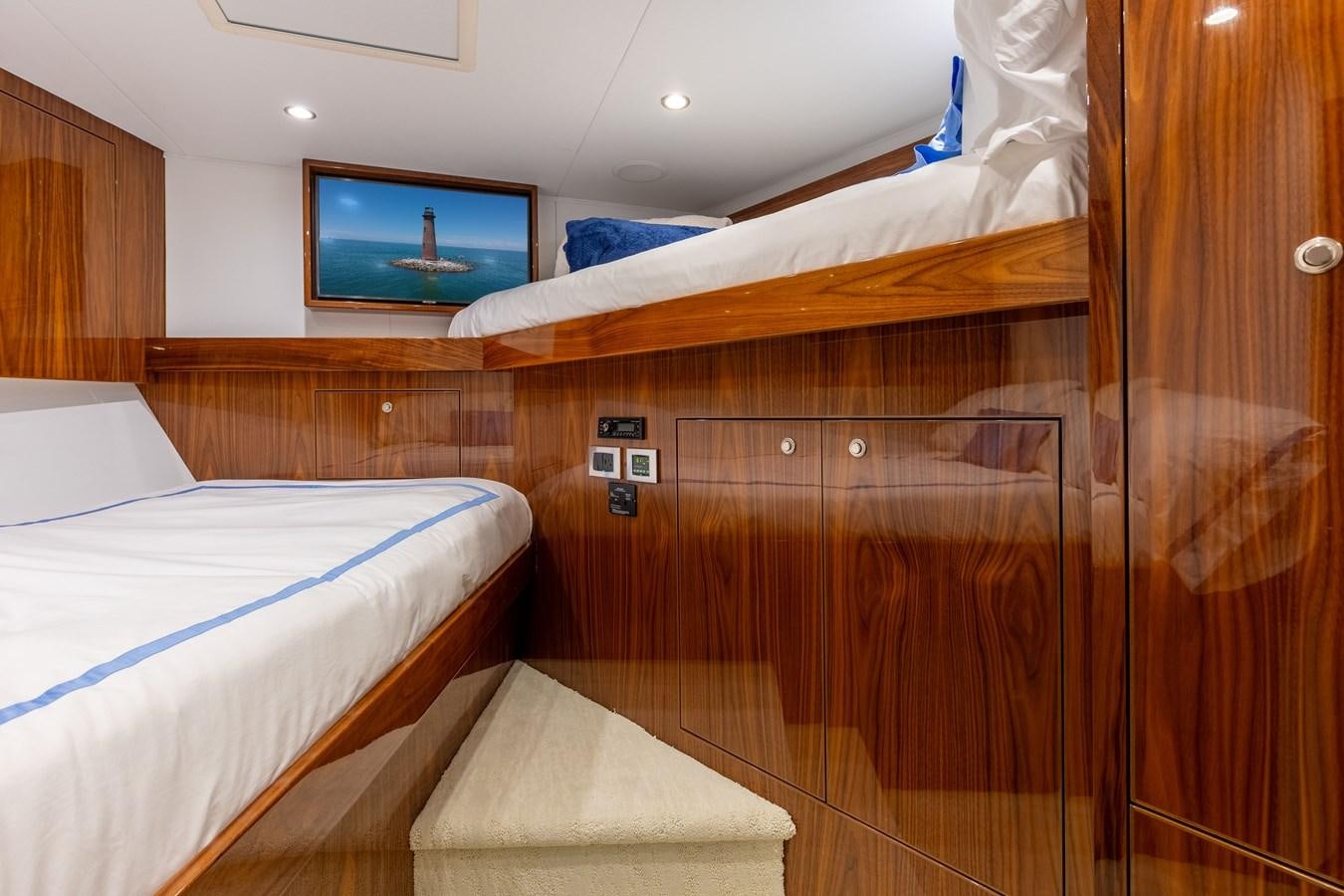 a room with a bed and a television aboard TEAM HARVEY Yacht for Sale