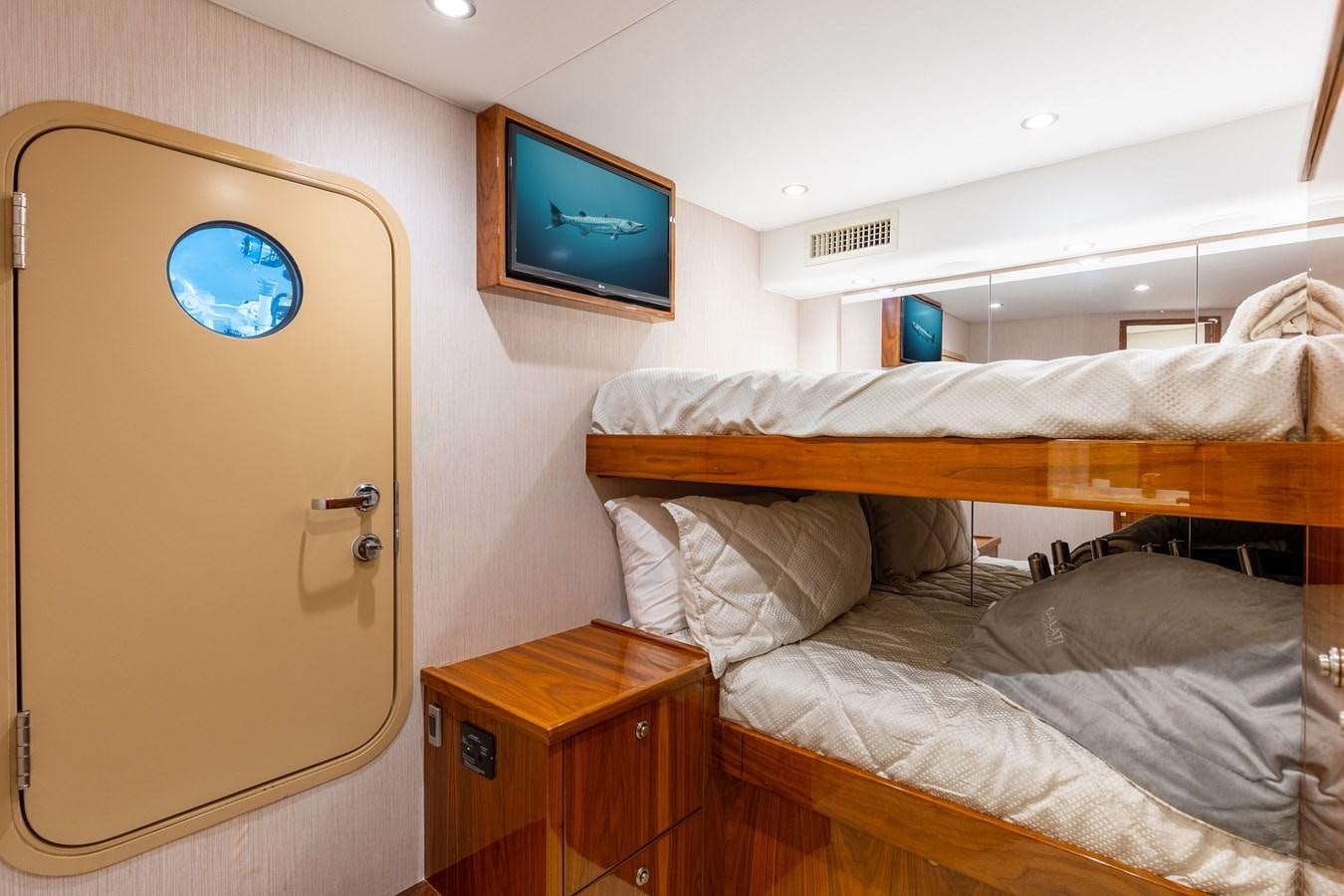 a bedroom with two beds aboard TEAM HARVEY Yacht for Sale