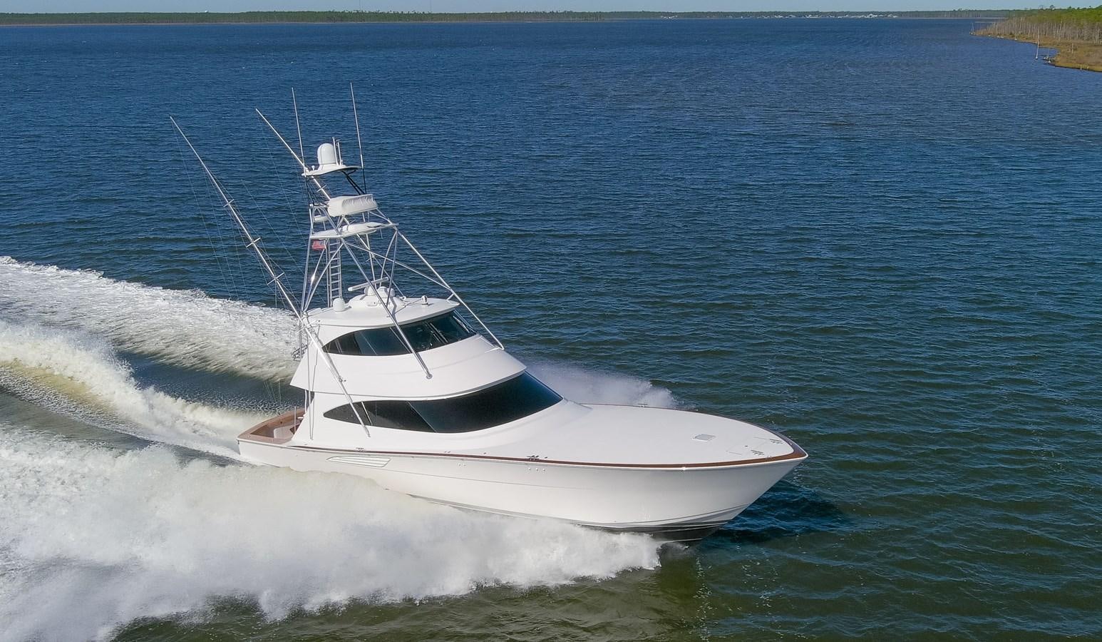 a white boat in the water aboard TEAM HARVEY Yacht for Sale