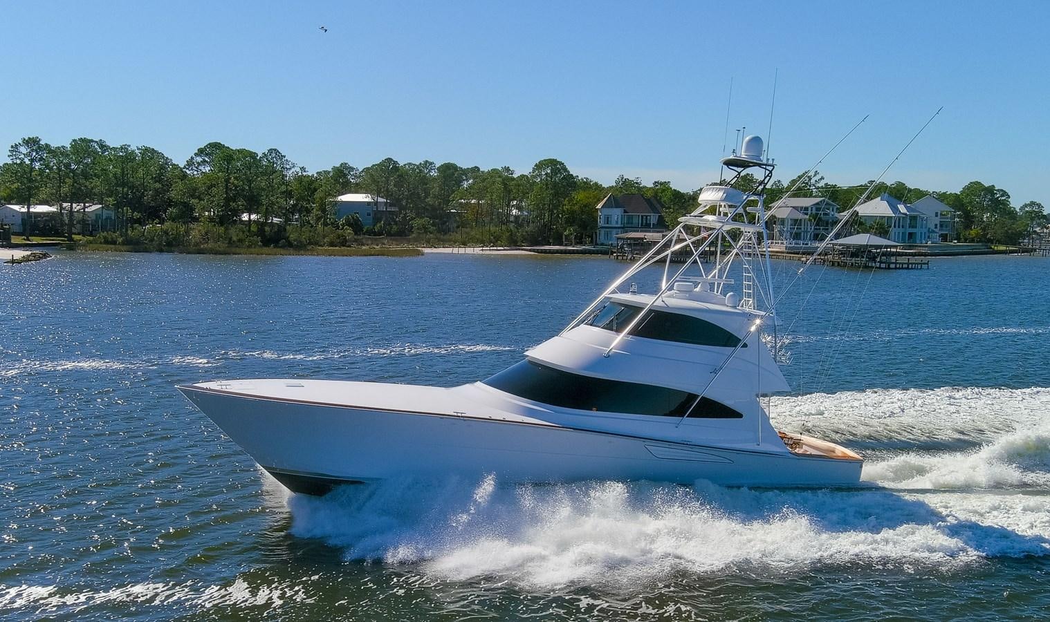 a white boat on the water aboard TEAM HARVEY Yacht for Sale