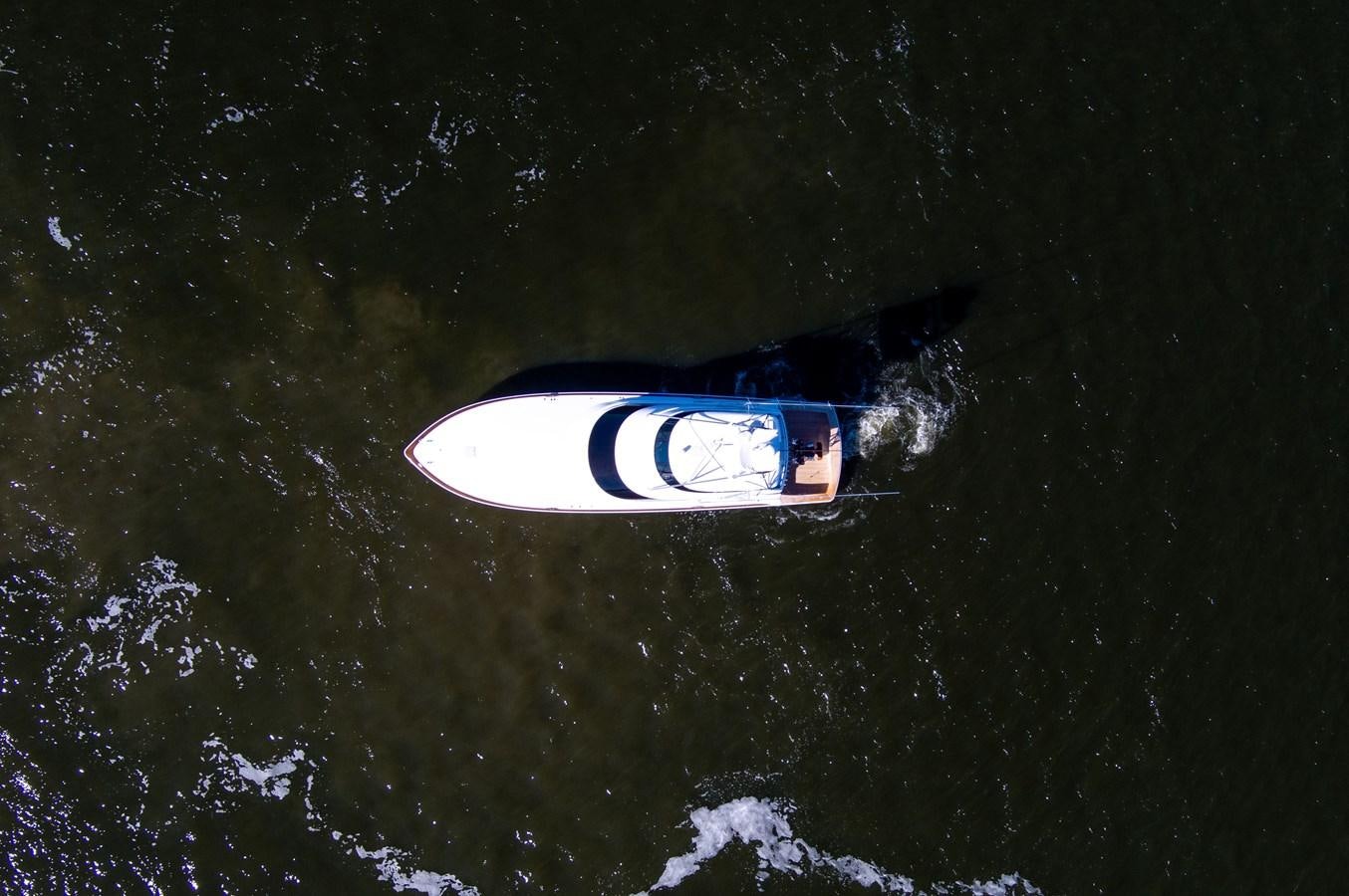 a person in a blue shirt aboard TEAM HARVEY Yacht for Sale