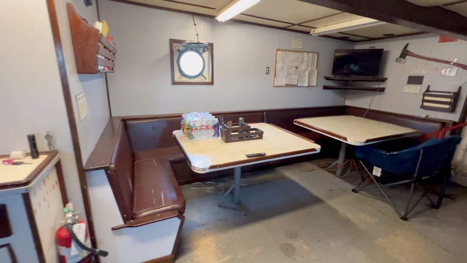 a room with desks and chairs aboard COMMERCIAL Yacht for Sale