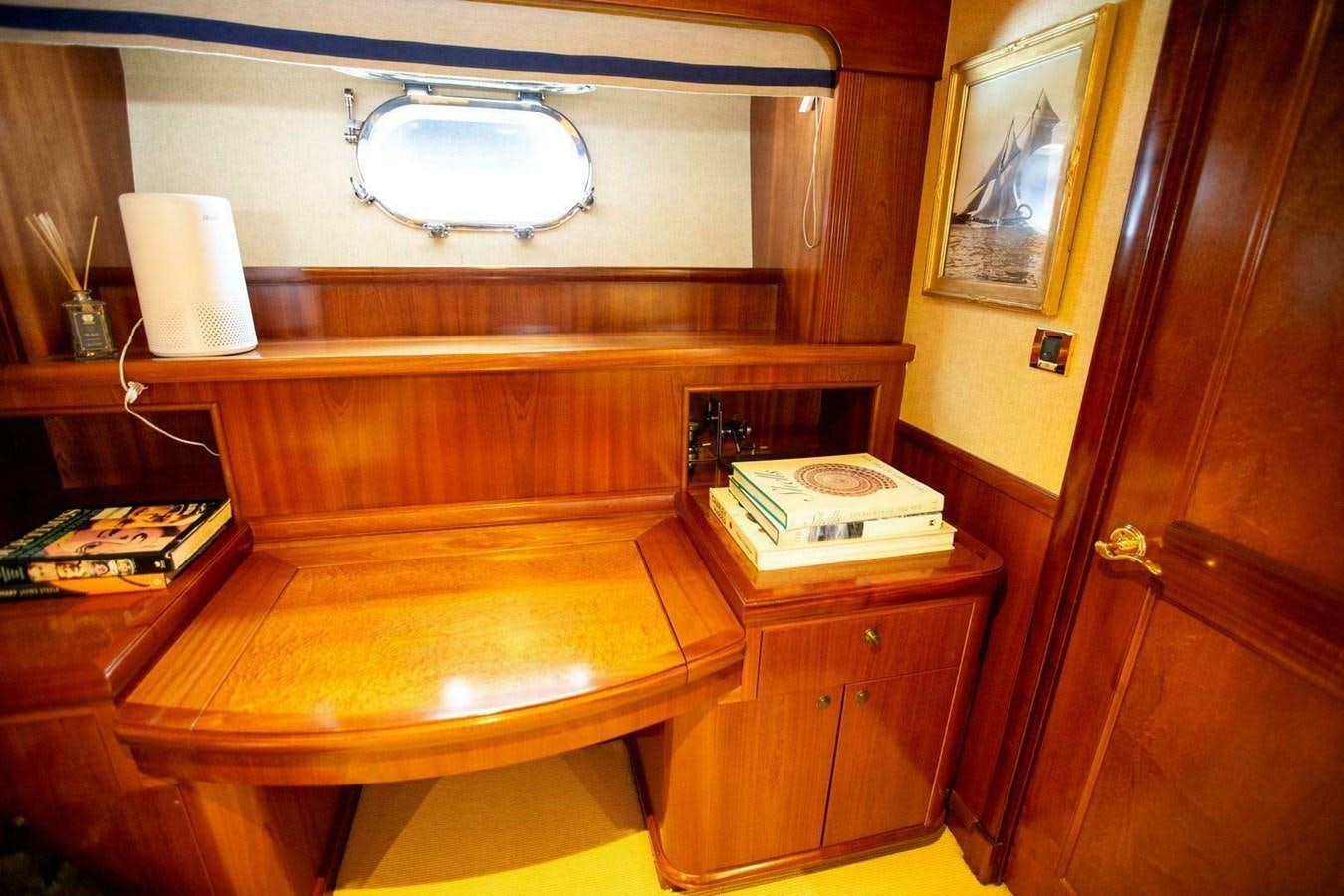 a desk with a lamp and a book on it aboard WATERFORD Yacht for Sale
