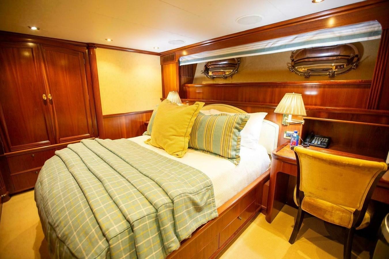a bedroom with a bed and desk aboard WATERFORD Yacht for Sale