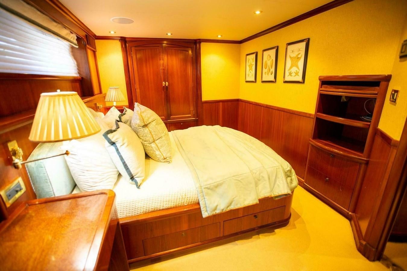 a bedroom with a bed and a piano aboard WATERFORD Yacht for Sale