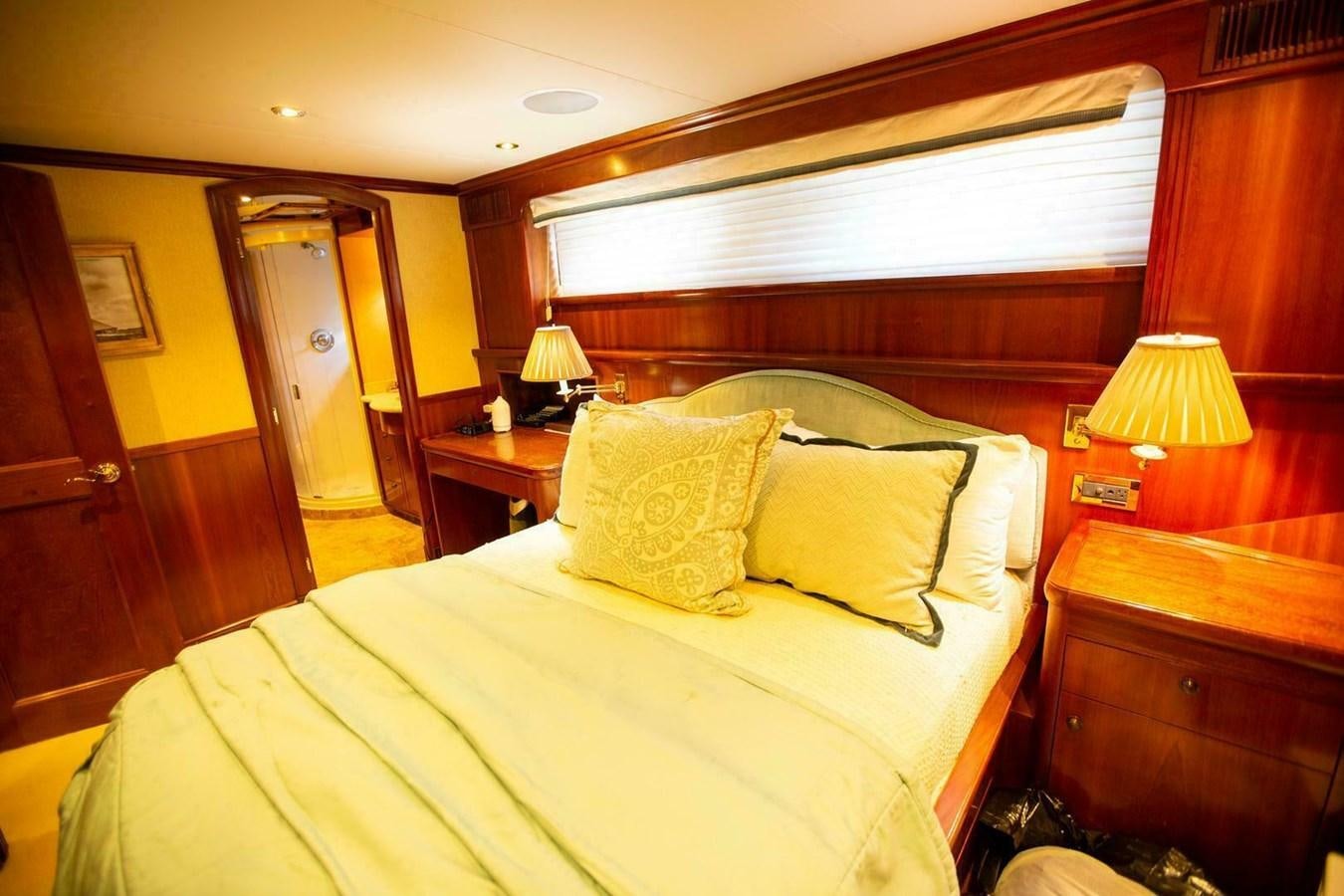 a bed with a lamp on it aboard WATERFORD Yacht for Sale