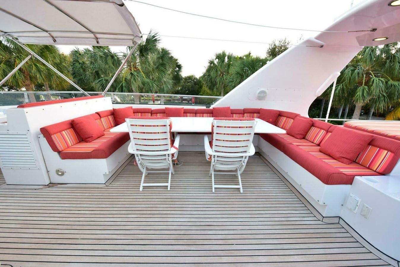 a deck with chairs and tables aboard WATERFORD Yacht for Sale