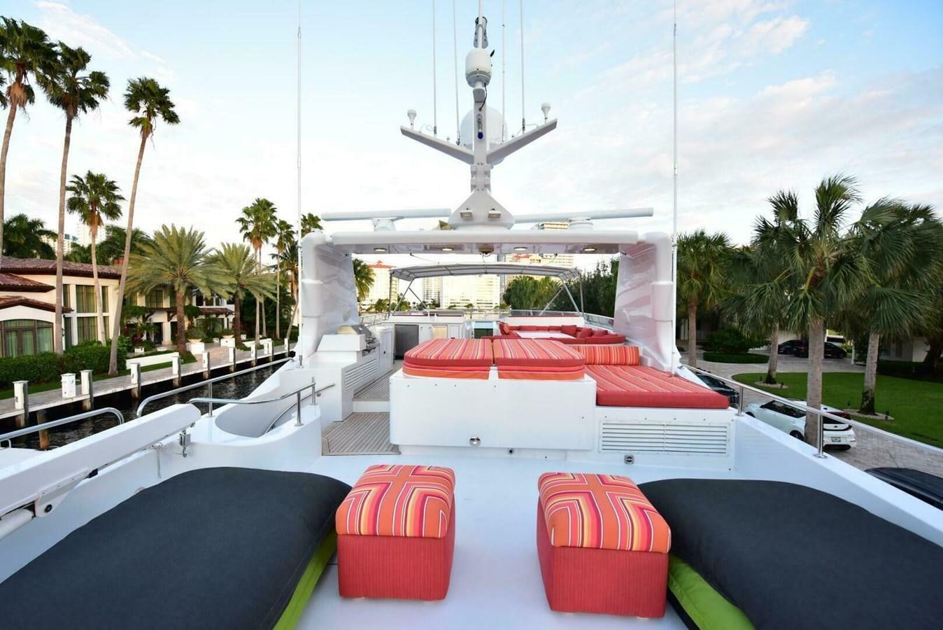 a pool with a fountain and palm trees and a building in the background aboard WATERFORD Yacht for Sale