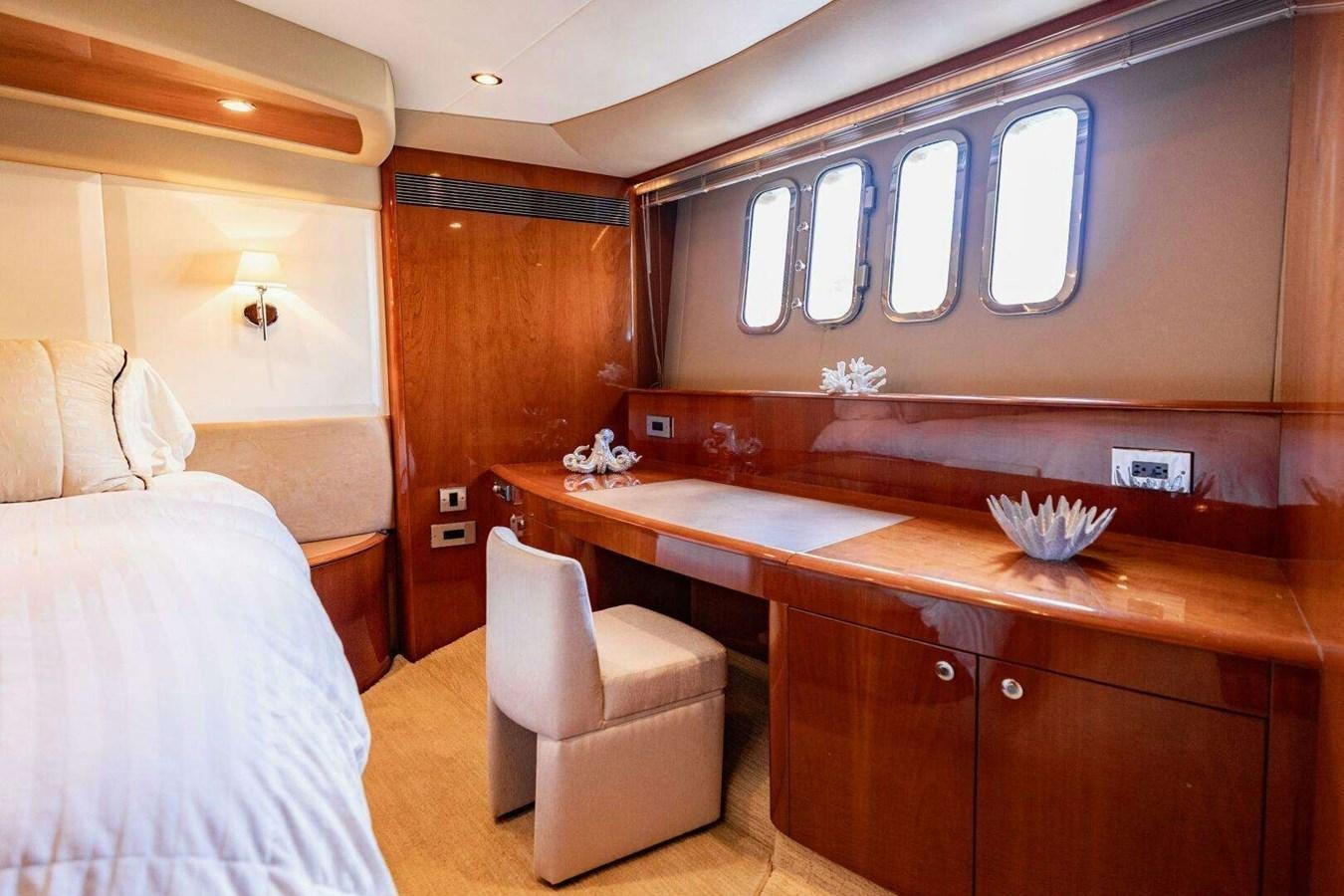 a room with a desk and a bed aboard TRINITY Yacht for Sale