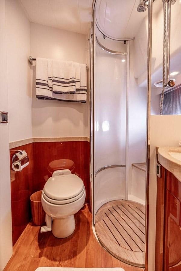 a bathroom with a shower and toilet aboard TRINITY Yacht for Sale