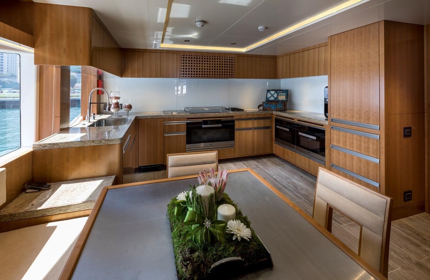 a kitchen with wooden cabinets aboard SEHAMIA Yacht for Sale
