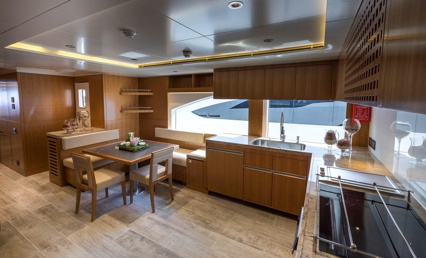 a kitchen with a table and chairs aboard SEHAMIA Yacht for Sale