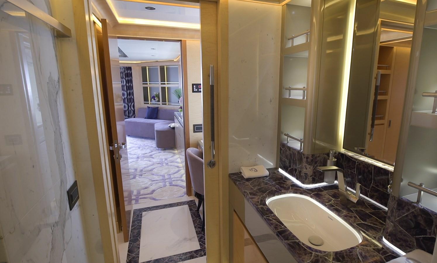 a bathroom with a sink and a bed aboard SEHAMIA Yacht for Sale