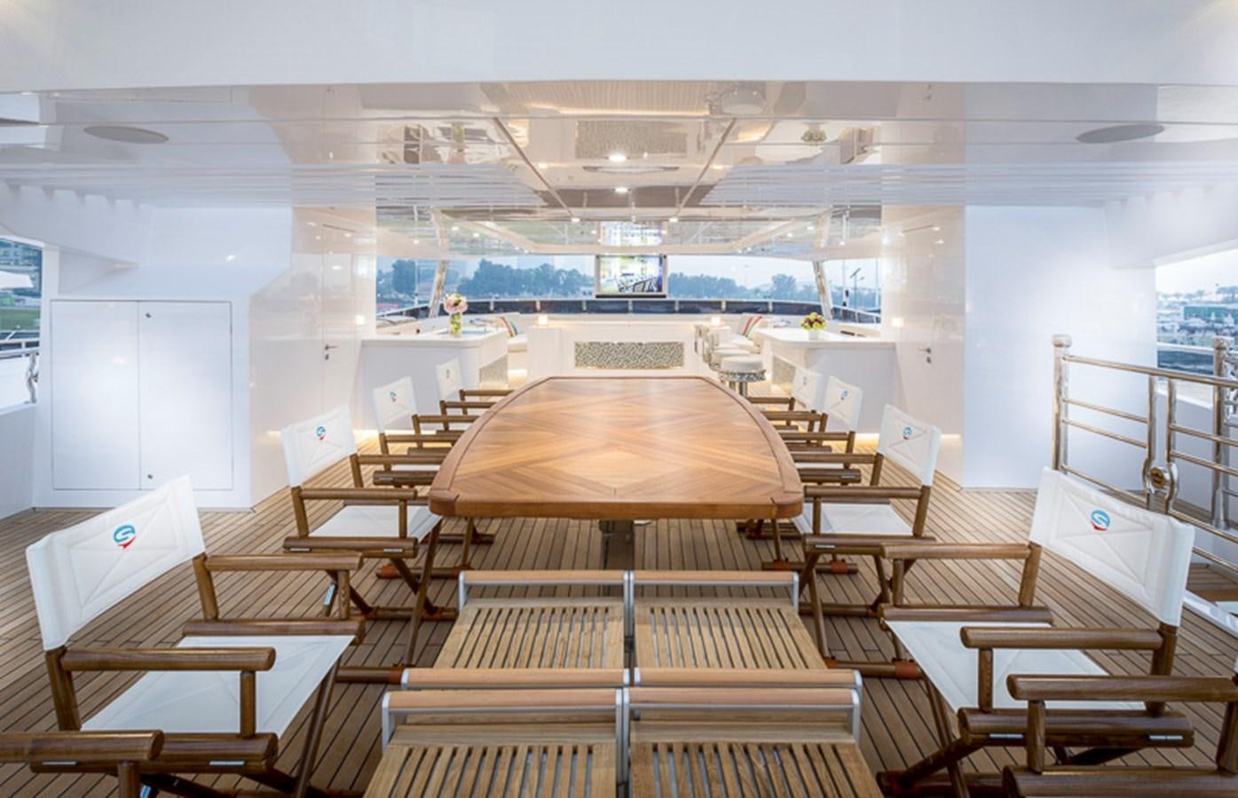 a room with tables and chairs aboard SEHAMIA Yacht for Sale