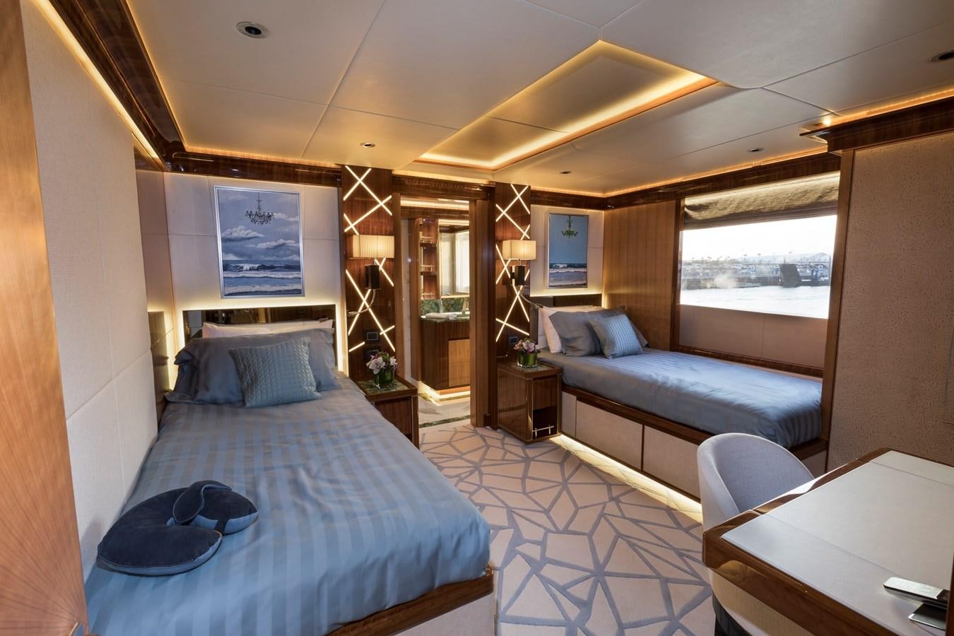 a bedroom with a bed and a couch aboard SEHAMIA Yacht for Sale