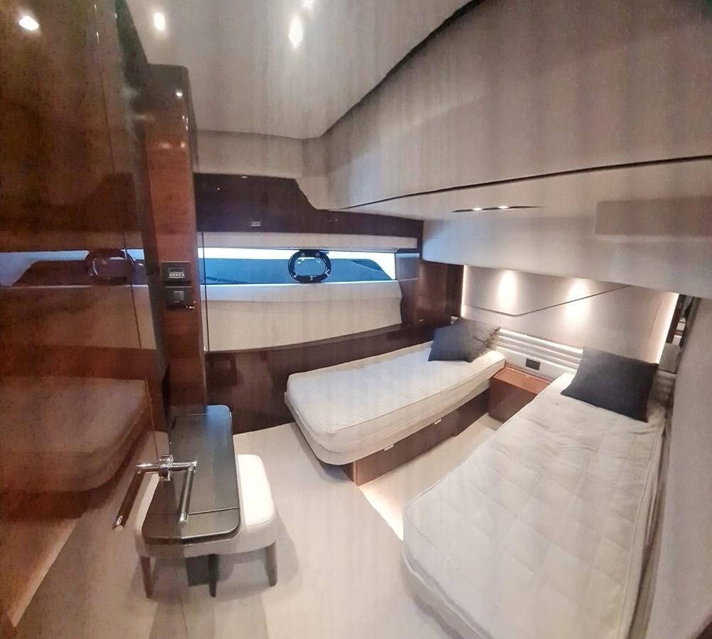 a room with a bed and a chair aboard ALEXANDRA II Yacht for Sale