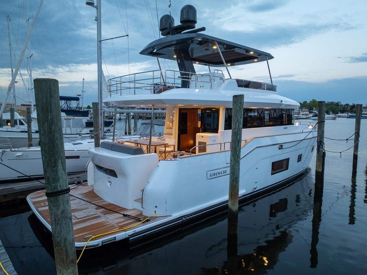 a boat docked at a pier aboard NEW 2023 SIRENA 68 Yacht for Sale