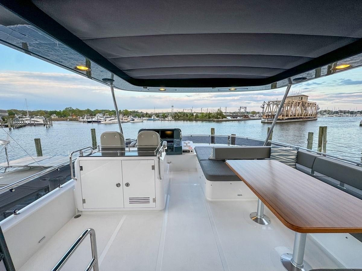 a boat dock with chairs aboard NEW 2023 SIRENA 68 Yacht for Sale