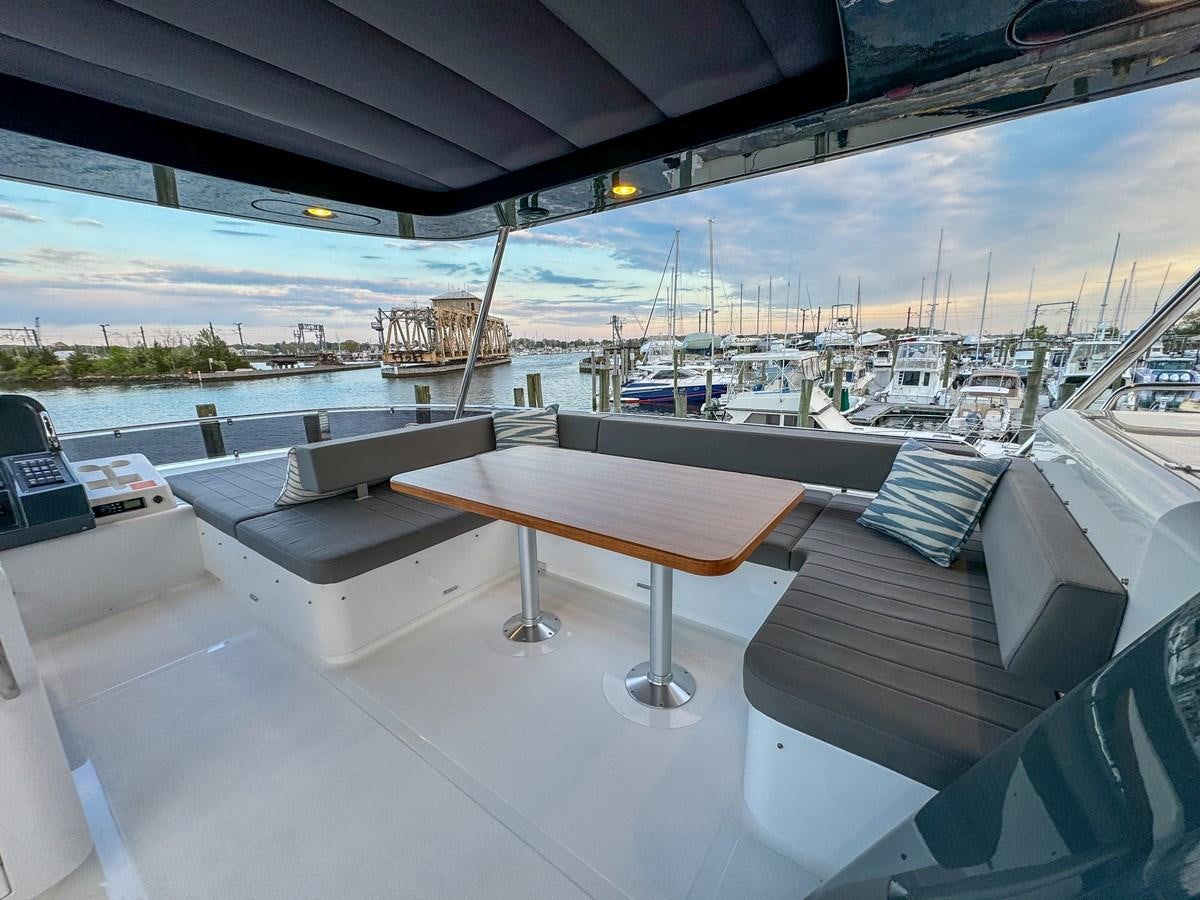 a table on a deck aboard NEW 2023 SIRENA 68 Yacht for Sale