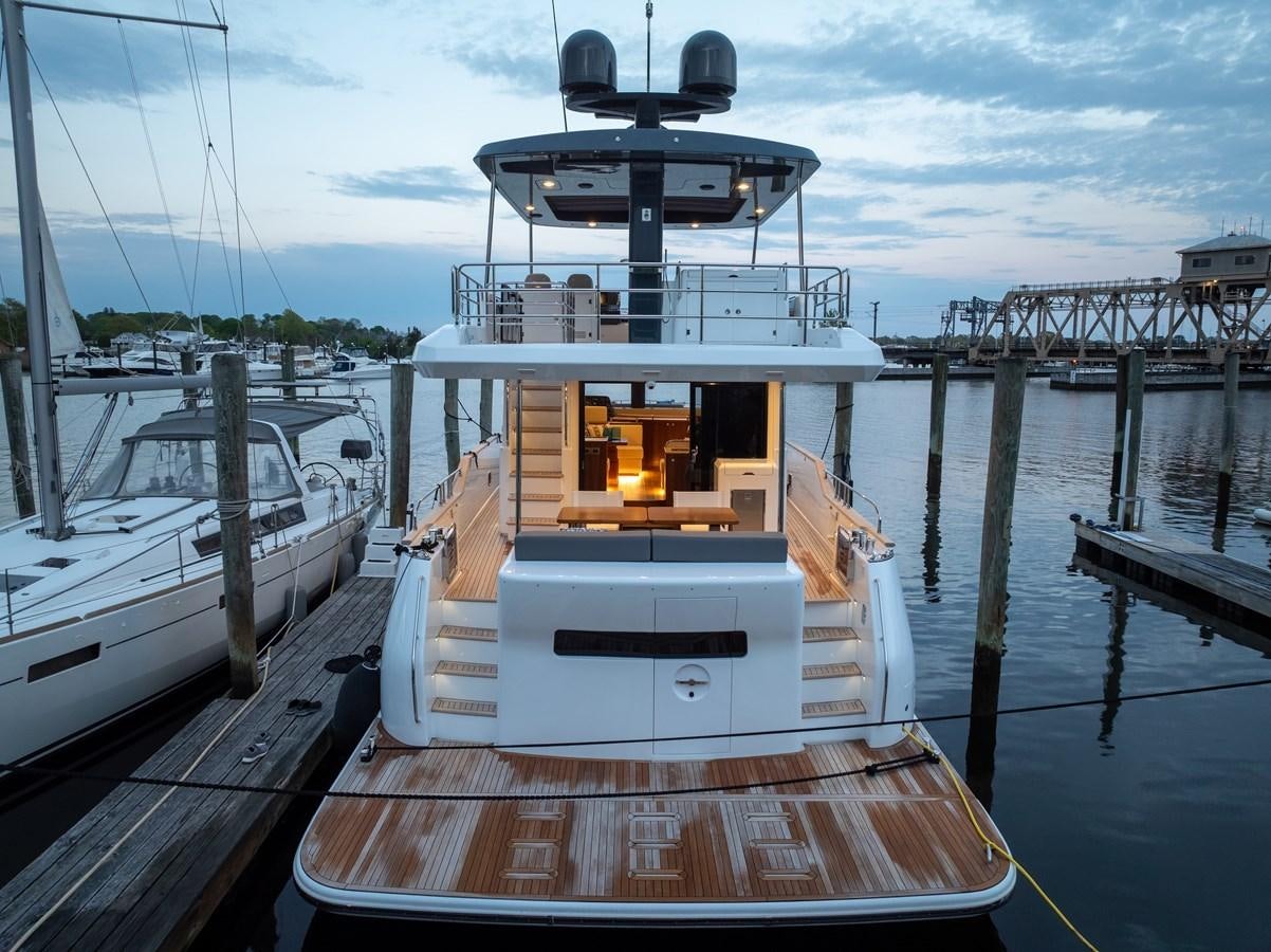 a large white boat docked at a pier aboard NEW 2023 SIRENA 68 Yacht for Sale