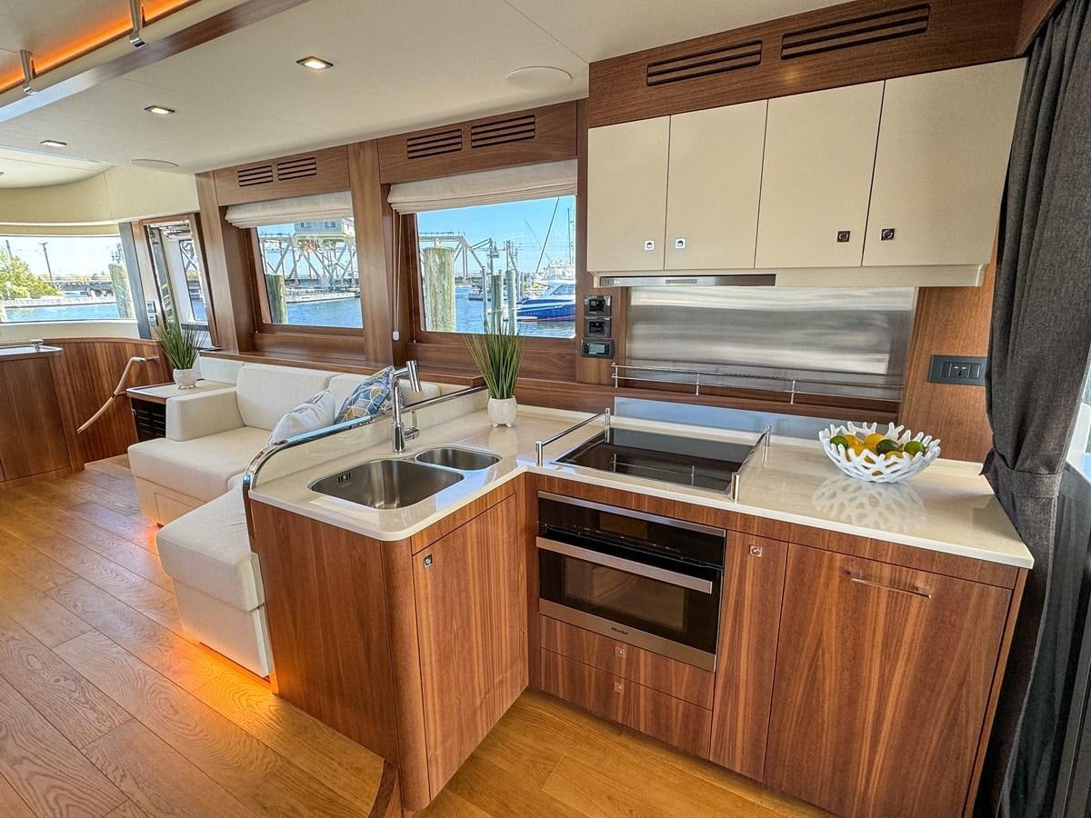a kitchen with a sink and a stove aboard NEW 2023 SIRENA 68 Yacht for Sale