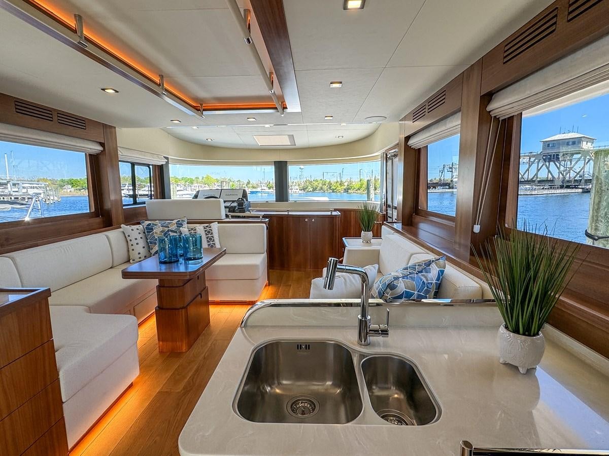 a modern looking kitchen with a large open floor plan aboard NEW 2023 SIRENA 68 Yacht for Sale