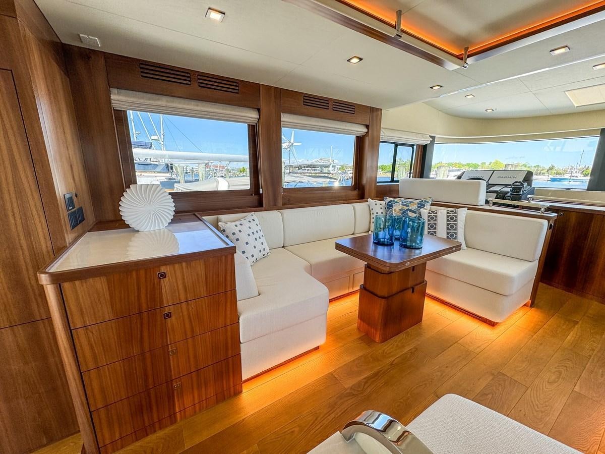 a living room with a couch and a coffee table aboard NEW 2023 SIRENA 68 Yacht for Sale