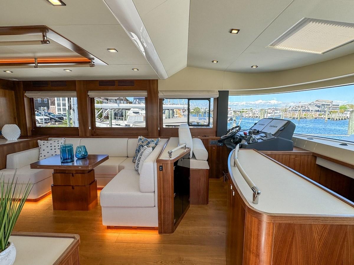 a living room with a large window aboard NEW 2023 SIRENA 68 Yacht for Sale