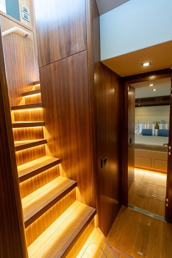 a wood staircase in a room aboard NEW 2023 SIRENA 68 Yacht for Sale
