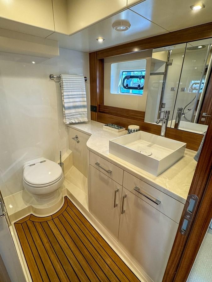 a bathroom with a sink and a toilet aboard NEW 2023 SIRENA 68 Yacht for Sale