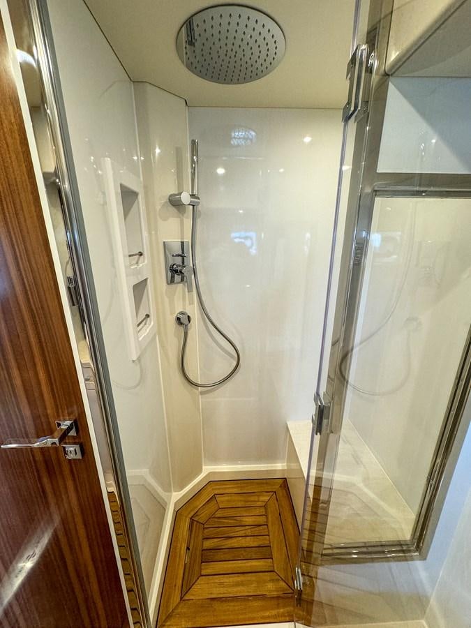 a bathroom with a large mirror aboard NEW 2023 SIRENA 68 Yacht for Sale