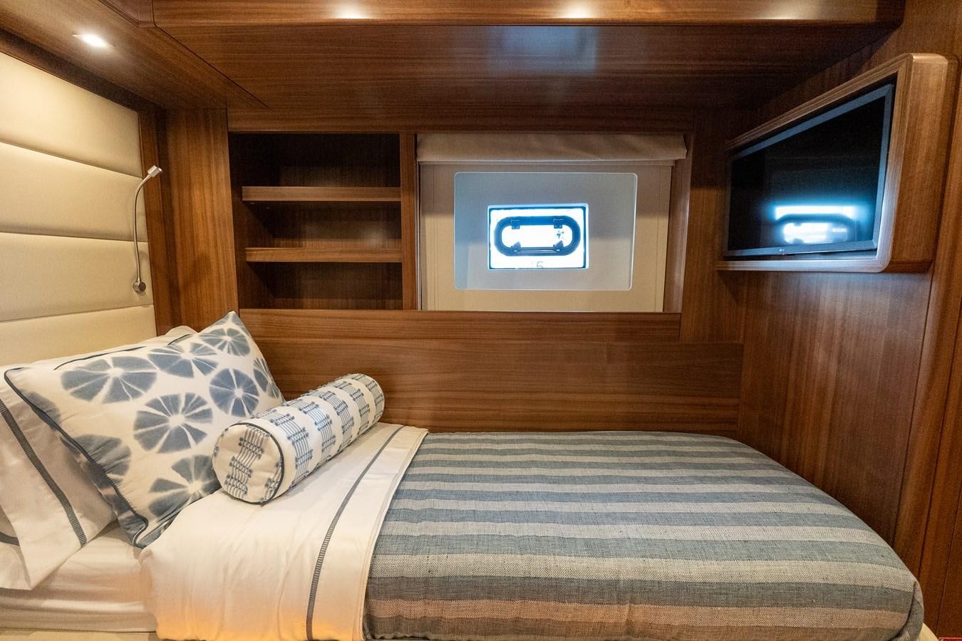 a bed with a television on the wall aboard NEW 2023 SIRENA 68 Yacht for Sale