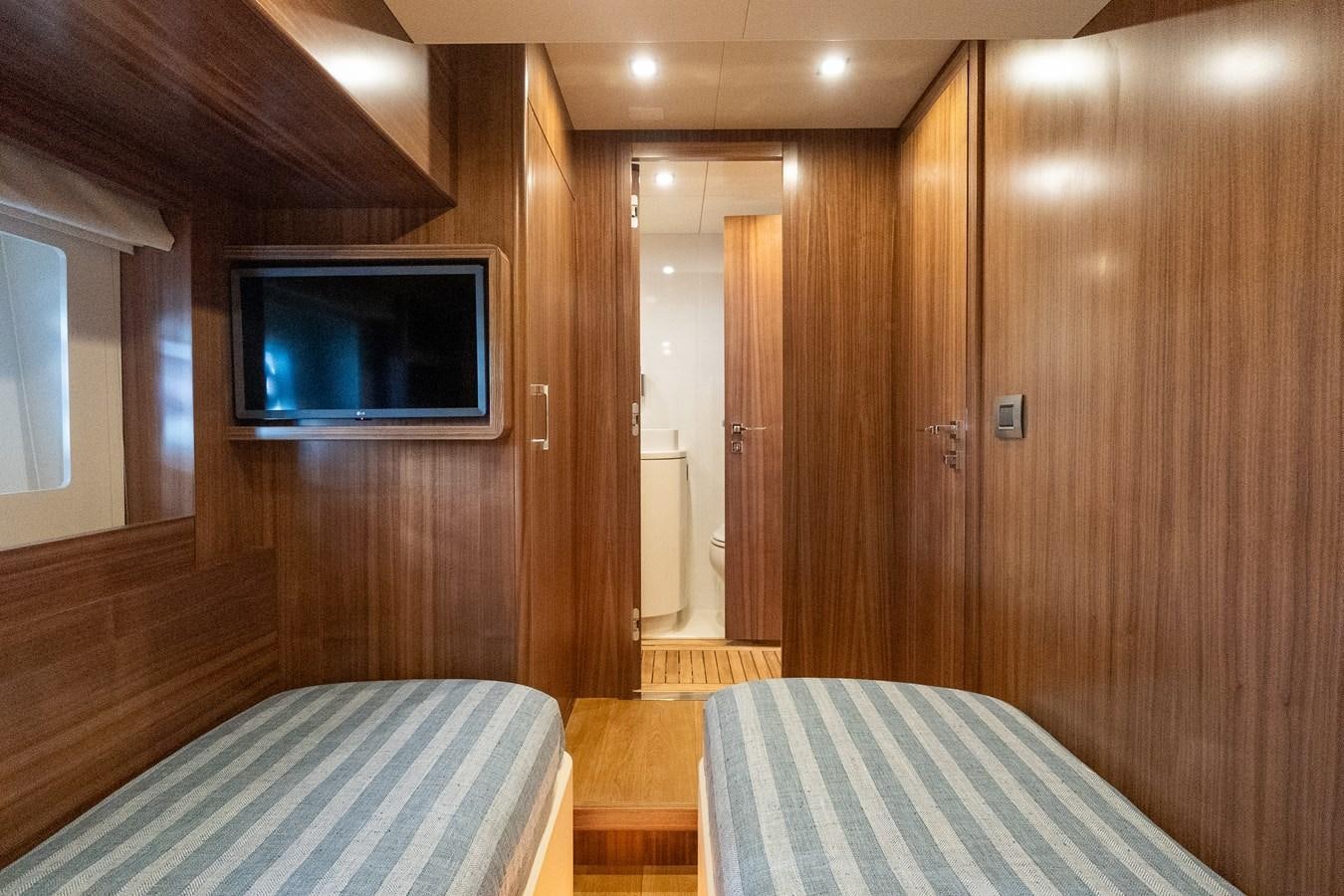 a room with a bed and a television aboard NEW 2023 SIRENA 68 Yacht for Sale