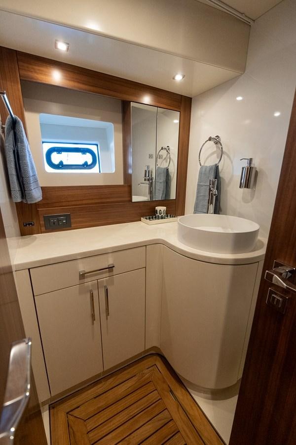a bathroom with a large mirror aboard NEW 2023 SIRENA 68 Yacht for Sale