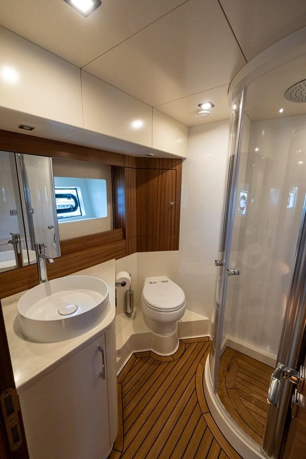 a bathroom with a sink toilet and a shower aboard NEW 2023 SIRENA 68 Yacht for Sale